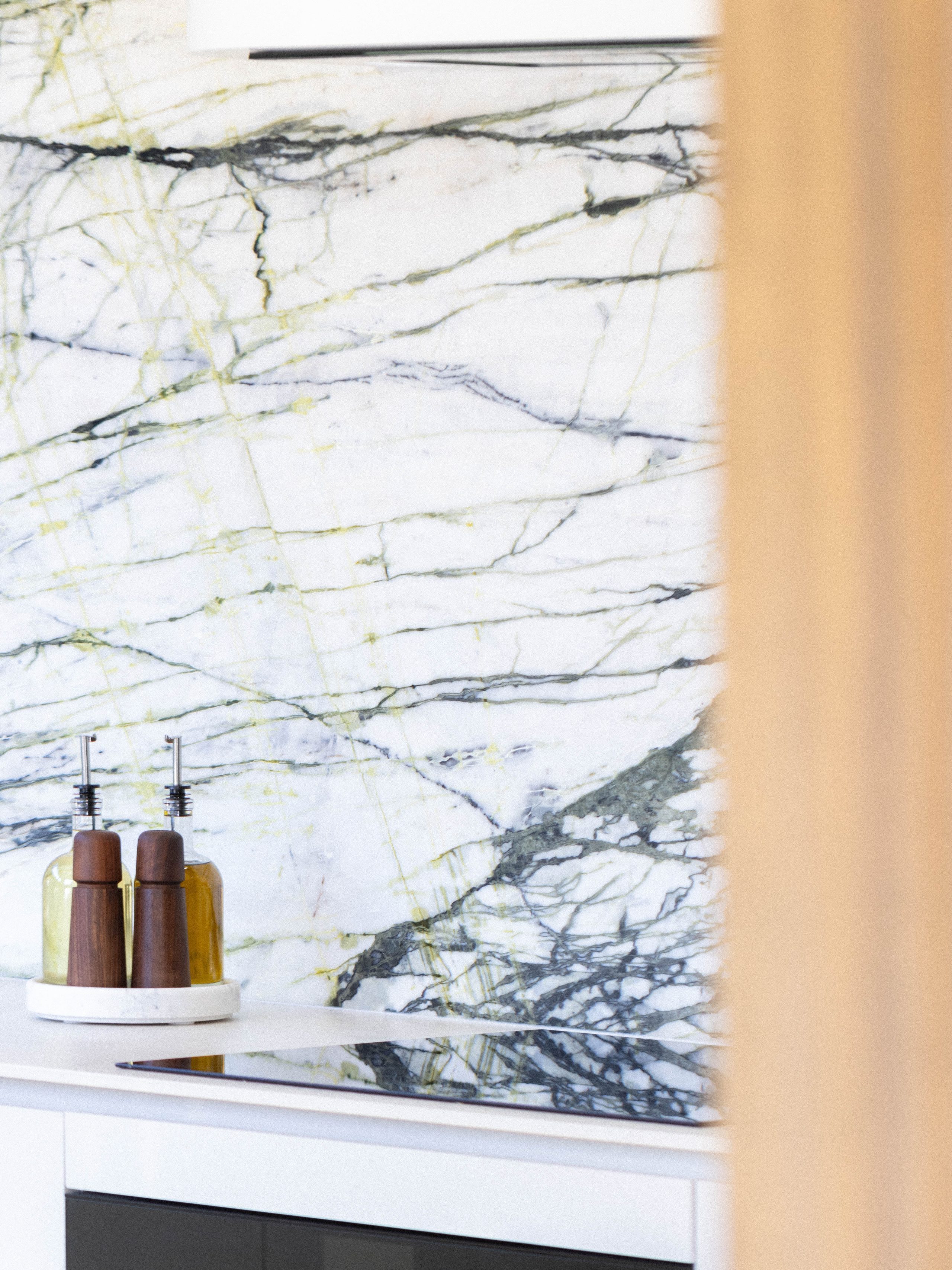 Custom kitchen with Melteca cabinetry and Calacatta Verde marble splashback in Bayswater, Auckland.