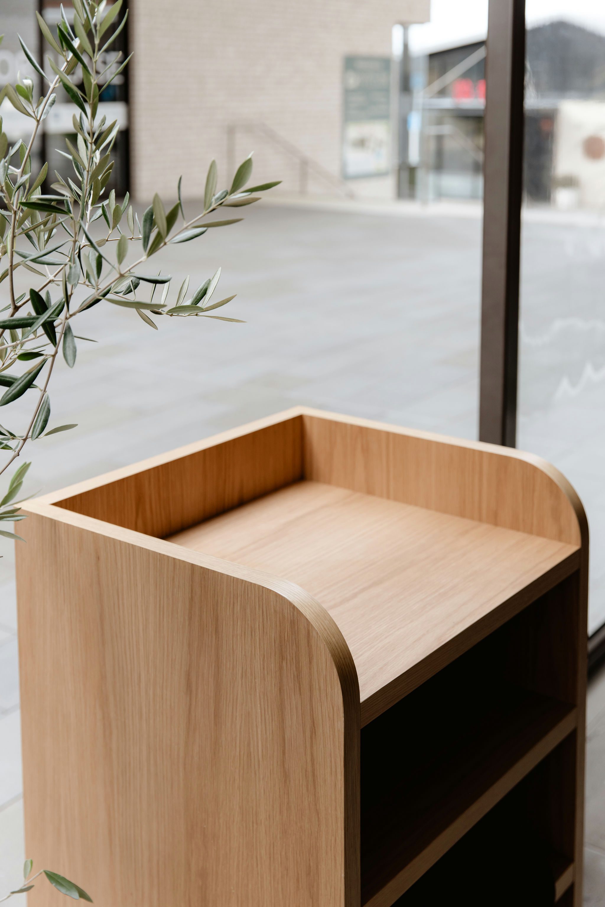 Close-up of oak storage cabinetry with curved end panel detail