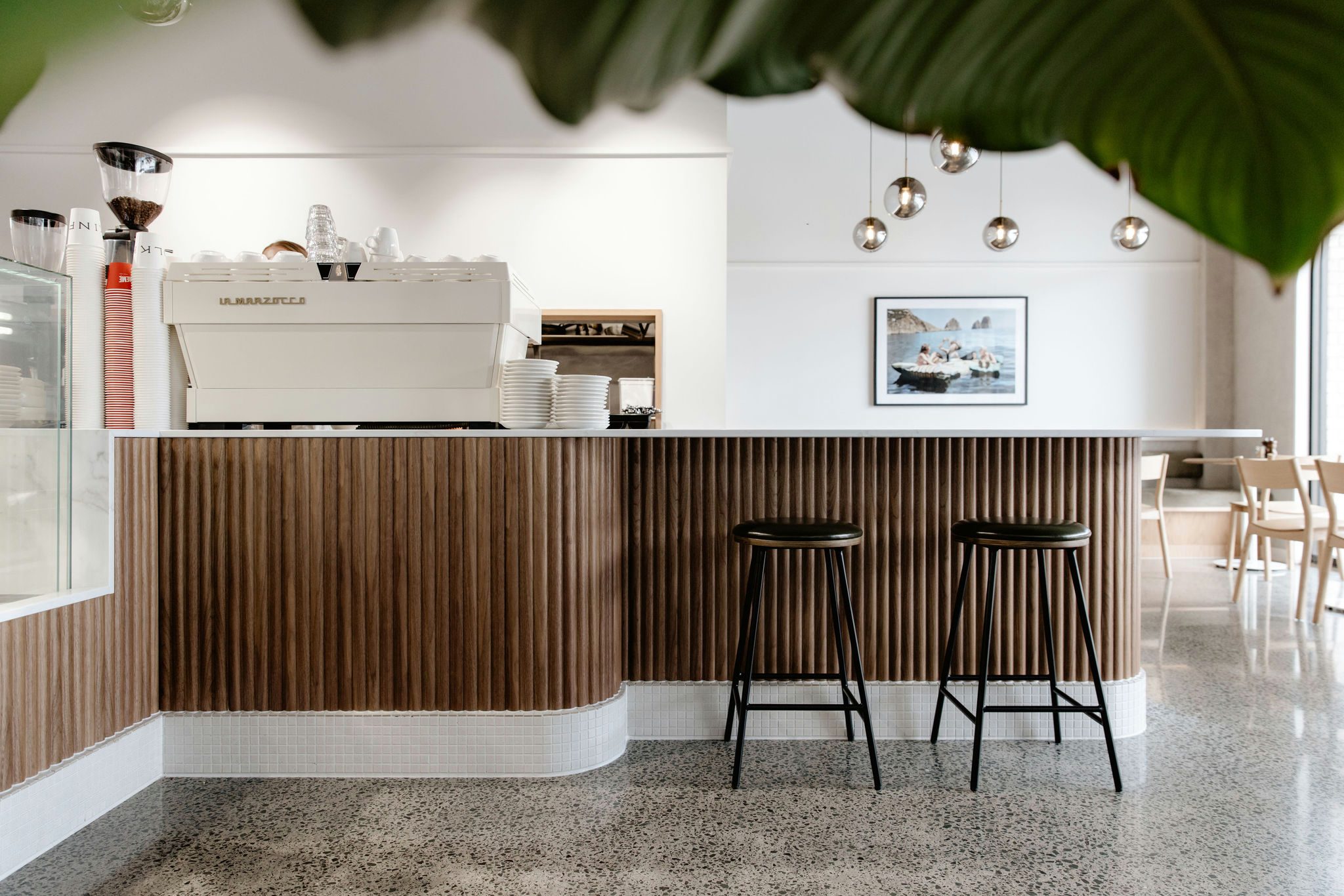 Custom counterfront with 8mm Walnut Wave Flex panels and Prime Stone Calacatta Gold countertop at Kinfolk Café, Long Bay