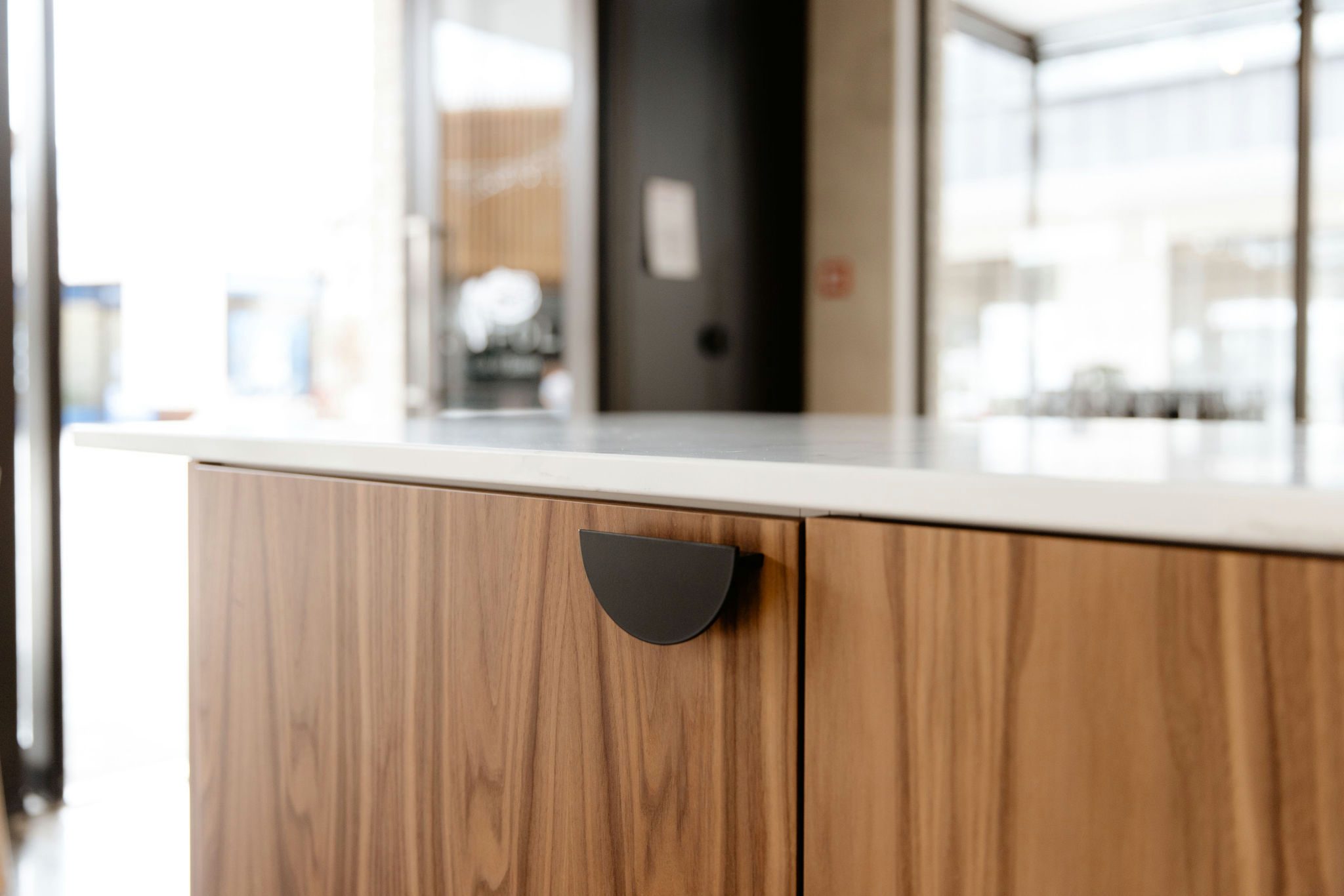 Close-up of oak door with rounded handle detail