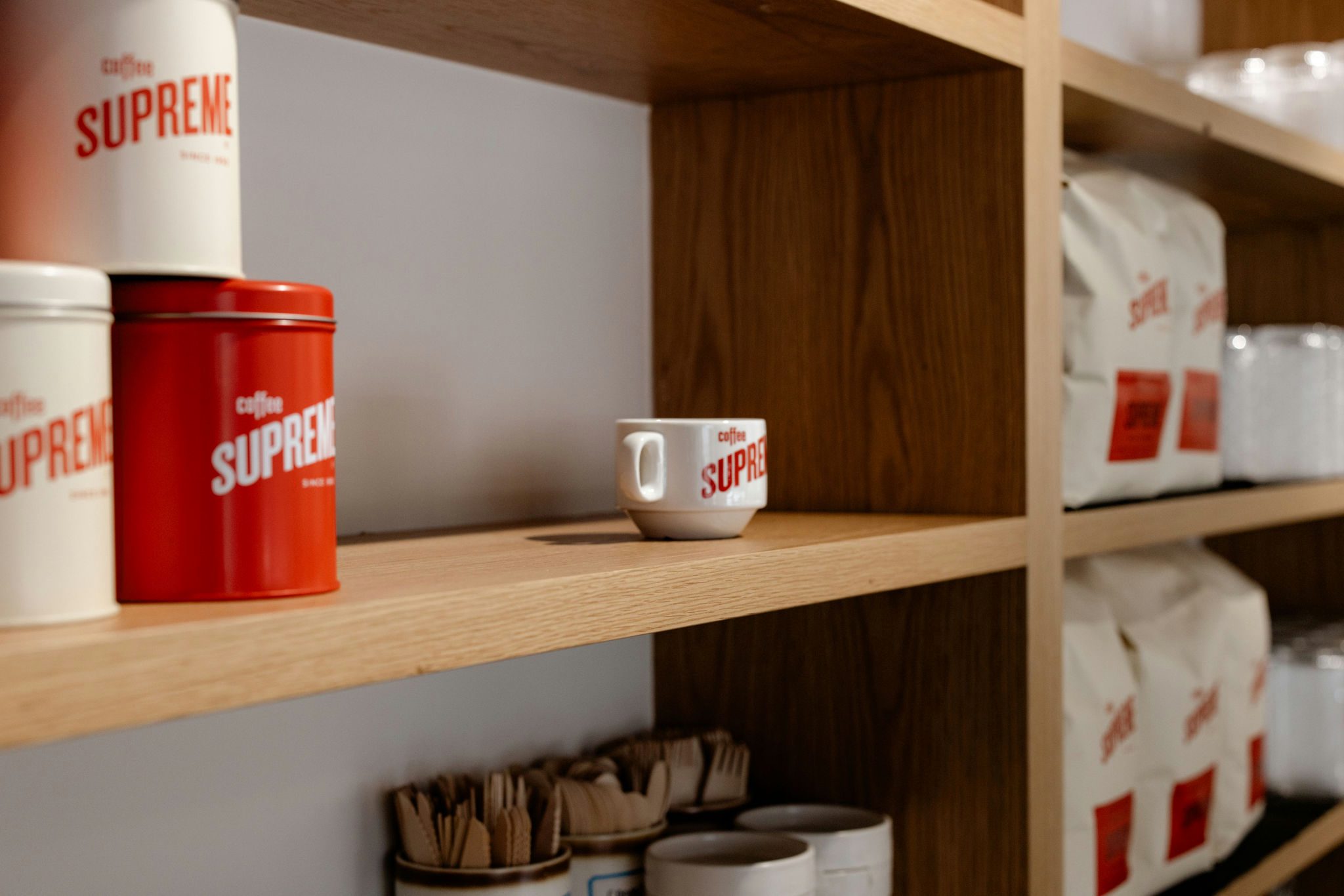 Landscape view of oak open shelving with coffee cups at Kinfolk Café, Long Bay