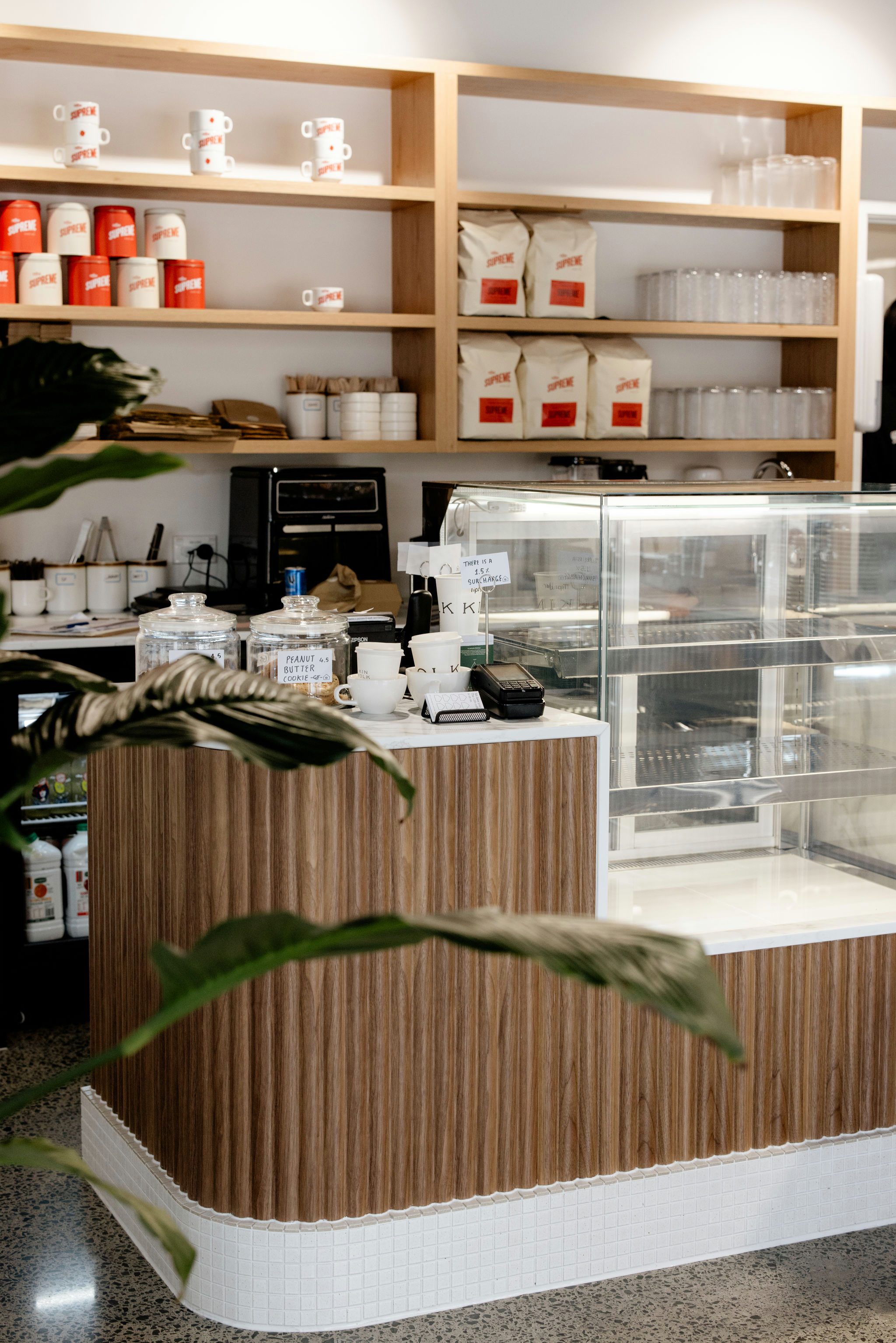 Angled view of custom counter and oak open shelving at Kinfolk Café, Long Bay