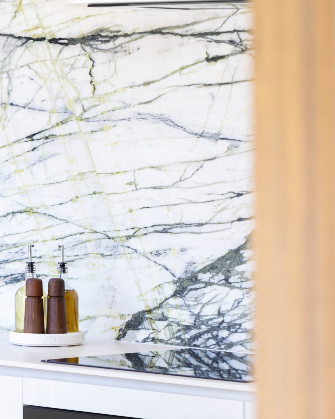 Custom kitchen with Melteca cabinetry and Calacatta Verde marble splashback in Bayswater, Auckland.